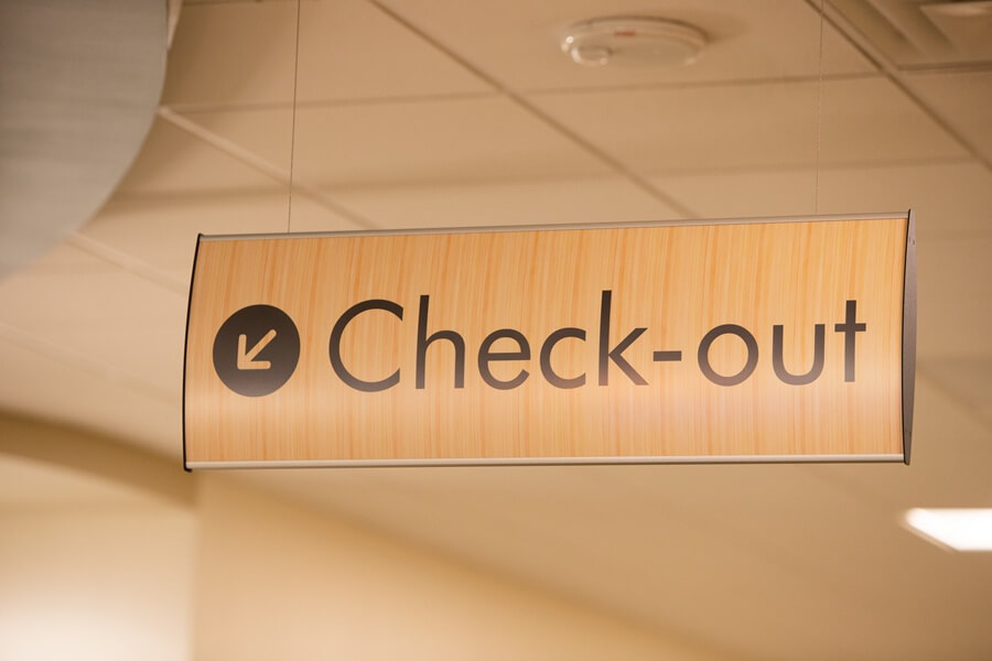 An image of the interior wayfinding signage for the "Check-out".